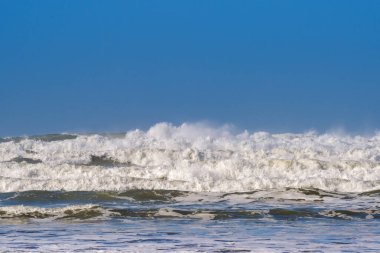 Breaking waves as the tide flows onto a beach. No people. Backgrounds.