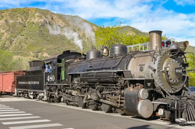Durango, Colorado, ABD - 23 Mayıs 2025: Durango ve Silverton dar ölçü demiryollarındaki eski buhar motoru Durango 'nun merkezindeki istasyondan ayrılıyor.
