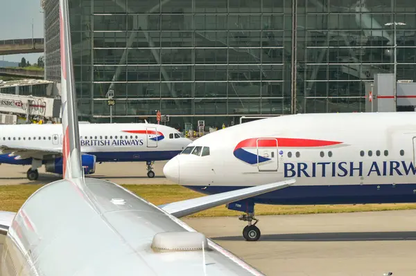 Londra, İngiltere, İngiltere - 20 Mayıs 2025: British Airways Boeing 777 ve Airbus jetleri Londra Heathrow Havaalanı 'ndaki Terminasl 5' in önünde
