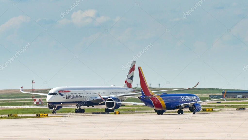 Denver, Colorado, USA - 4 June 2025: Passenger planes operated by British Airways and Southwest Airlines passing on the ground at Denver International Airport.
