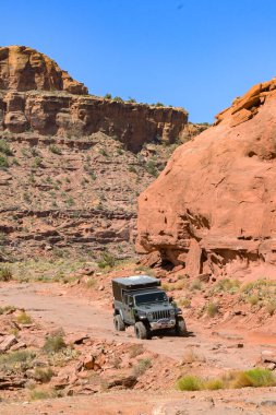 Moab, Utah, ABD - 25 Mayıs 2025: Moab 'ın kenar mahallelerinde engebeli arazide giden arazi aracı