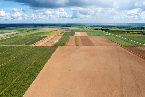 stock image Aerial view of planted and unplanted agricultural fields and irrigation in Homestaed, Florida under summer cloudscape.