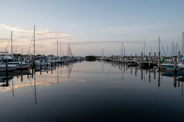 stock image Miami, Florida - July 8, 2023 - Yachts and sailboats docked in Dinner Key Marina in Coconut Grove in morning twilight on clear calm summer day.