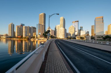 Brickell Key Bridge and City of Miami skyline at sunrise under clear blue sky on tranquil December morning. clipart