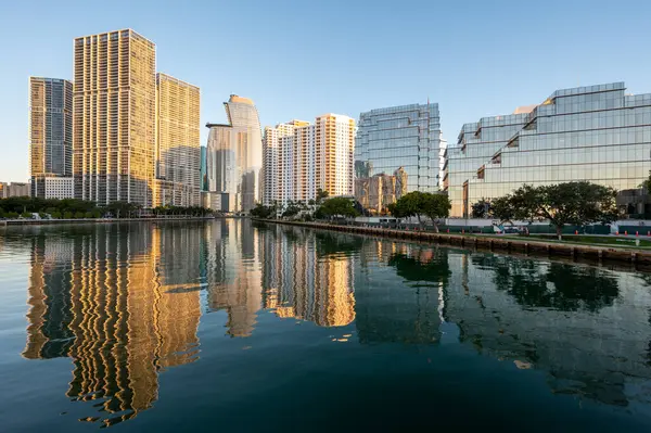 Miami, Florida silueti, bulutsuz bir Aralık sabahı gün doğumunda Biscayne Körfezi 'nin sakin sularına yansıdı..