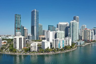 Aerial image of waterfront residential buildings in Brickell neighborhood of Miami, Florida reflected in calm water of Biscayne Bay on sunny morning. clipart