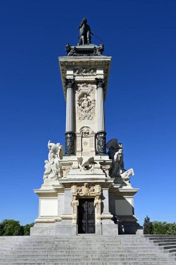 Madrid, İspanya - 13 Nisan 2024 - Güneşli bir bahar sabahı El Retiro Parkı 'nda Kral XII. Alfonso Anıtı.