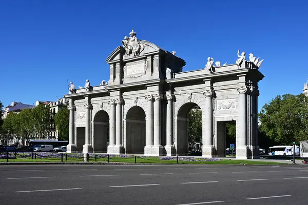 stock image Madrid, Spain - April 12, 2024 - Puerta de Alcala - Alcala Gate - on Alcala Street on clear sunny spring morning.