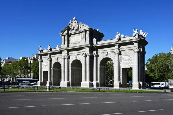 Stock image Madrid, Spain - April 12, 2024 - Puerta de Alcala - Alcala Gate - on Alcala Street on clear sunny spring morning.