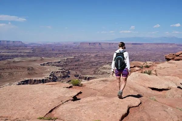 stock image Woman hiking on White Rim Overlook Trail in Canyonlands National Park, Utah on clear sunny summer afternoon.