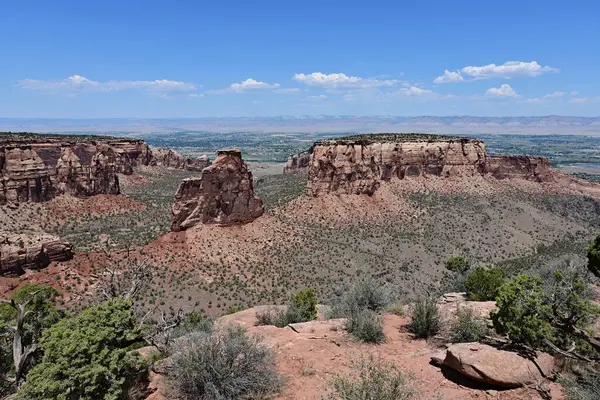 stock image Scenic view in Colorado National Monument on clear sunny summer day with city of Fruita, Colorado visible in background.