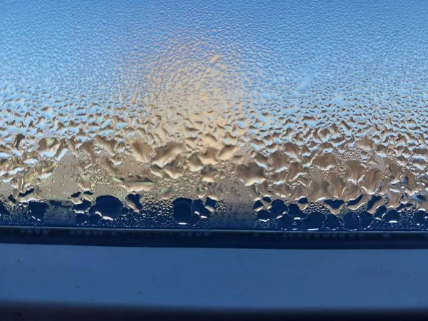 Window covered with frozen drops of the condensate water