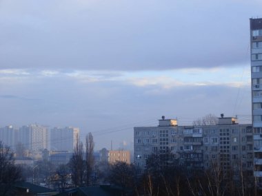 Morning winter fog hangs over a the city