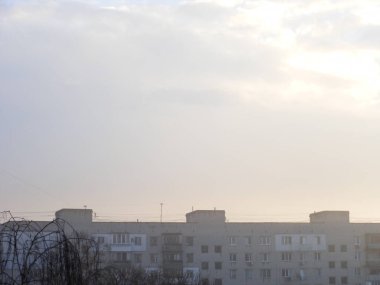 Morning winter fog hangs over a the city