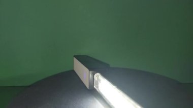 Led lamp with a power bank is spinning on a stand