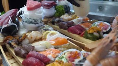 Yetenekli bir elin, tuna balığını ince ince dilimleyip, enfes bir deniz ürünleri çeşidiyle çevrili büyük bir tabakta enfes bir balık hazırlayarak, bir mutfak başyapıtı yaratması gibi yemek pişirme sanatını tecrübe edin..