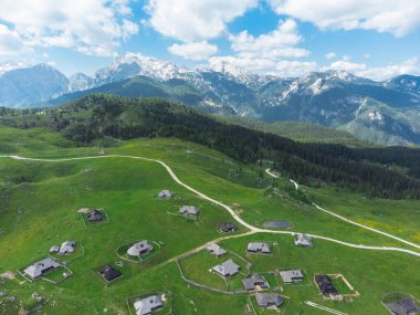 Aerial View of Mountain Cottages on Green Hill of Velika Planina Big Pasture Plateau, Alpine Meadow Landscape, Slovenia clipart