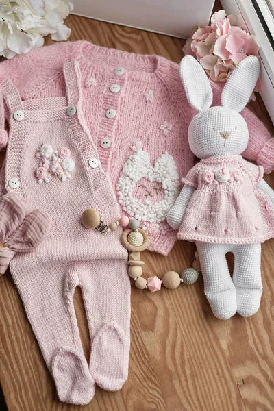 Baby knitted clothes and toys. Handmade knitted clothes with embroidery