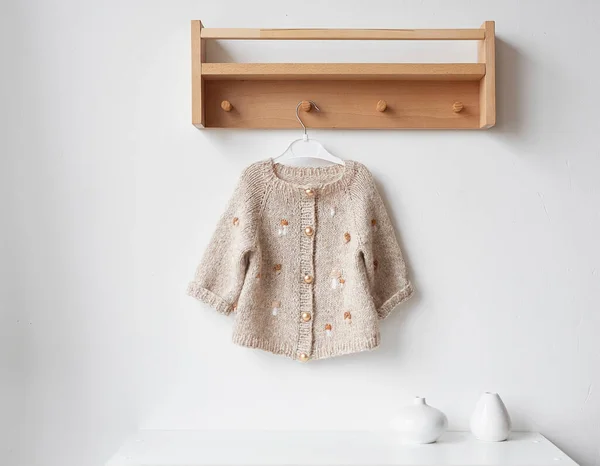 Baby knitted clothes. Handmade knitted clothes with embroidery