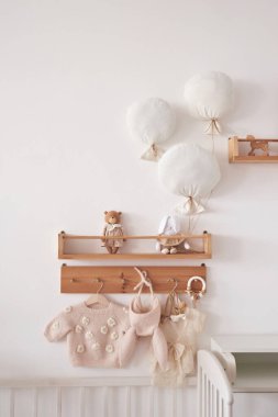 Baby knitted clothes on hanger. Preparation for childbirth