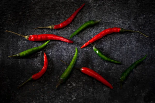 stock image red hot chili peppers on black background dark mood food concept