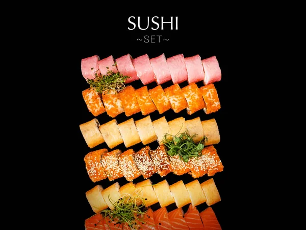 stock image Variety of Japanese sushi roll pieces isolated on black background. Large set with salmon, tuna, shrimp, avocado, cucumber with micro greens on top. Ready banner concept with text, copy space