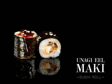 Side view of Maki sushi roll pieces with mirror reflection on black background. Sushi roll with Eel and nori seaweed, Unagi sauce on top. Ready menu advertising banner with text and copy space.