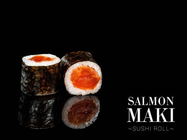 Close up to Maki sushi roll pieces with mirror reflection on black background. Sushi roll with marinated salmon and nori seaweed on top. Ready menu advertising banner with text and copy space.