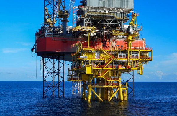 Oil well platform on offshore drilling rig with blue sky background
