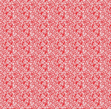 Geometrik motif desenli kırmızı ve turuncu ambalaj kağıtları desenli bir halıya konur..