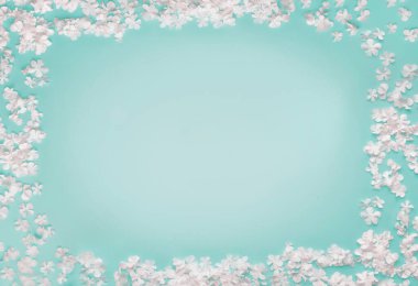 Turkuaz mavi arka planda küçük beyaz çiçeklerden oluşan güzel bir çerçeve, üst manzara, kopyalama alanı. Düz yatıyordu