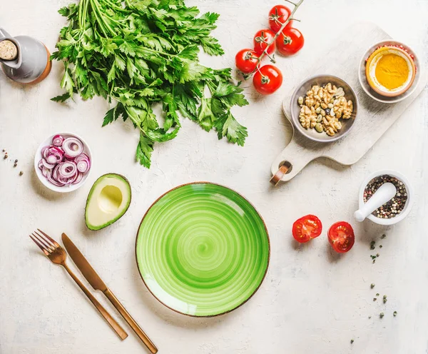 カトラリーや食材と空のプレート アボカド ハーブ トマト 玉ねぎ スパイス 家庭での健康的な料理 白いテーブル トップ表示 — ストック写真