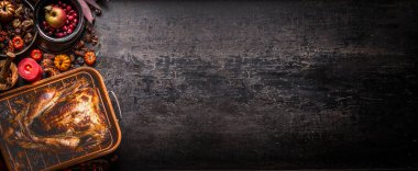 Sonbahar malzemeleri, balkabakları, mumlar, fındıklar ve süslemelerle dolu koyu kırsal masada kavrulmuş hindiyle Şükran Günü arkaplanı. Üst Manzara. Pankart. Tasarımınız için alanı kopyalayın