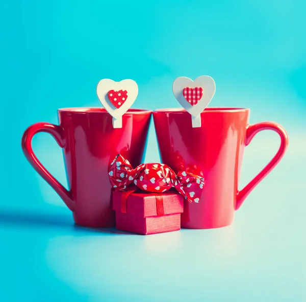 Two Red Mugs Hearts Candies Presents Blue Background — Stock Photo, Image