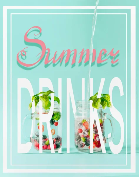 Creative summer drinks concept with text and berries detox fruit infused water in Mason jar flavored with herb leaves at sunny turquoise blue background. Summer mood.  Healthy drinks and lifestyle.