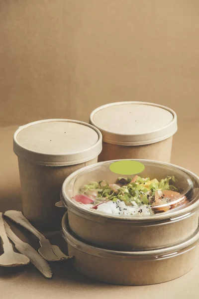 Modern sustainable food delivery with healthy lunch in plastic free  boxes from craft-paper. Eco-friendly lifestyle with biodegradable material. Front view.