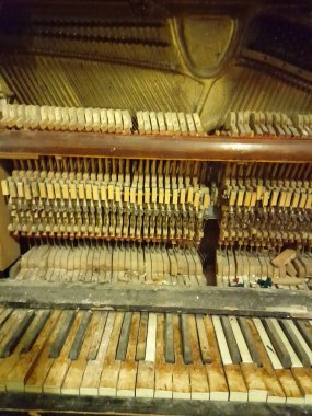 Old broken piano. Vintage background with old piano. Broken piano
