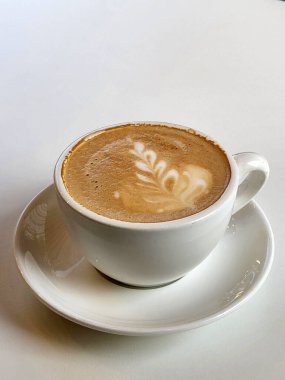 Kahve demledim. Beyaz arka planda beyaz bir fincanda demlenmiş kahve.