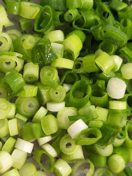 Green onions. Chopped green onions for salads. Culinary background of finely chopped onions