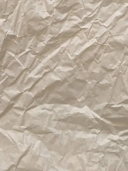 Crumpled paper. Crumpled light parchment. Vintage crumpled paper background