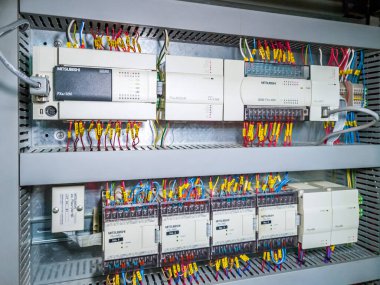 Mitsubishi PLC modules in a row in electrical cabinet of automation control system on industrial plant. KRYVYI RIH, UKRAINE - JANUARY, 2023