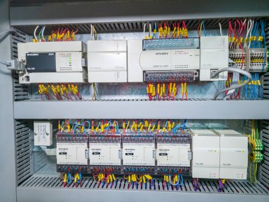 Mitsubishi PLC modules in a row in electrical cabinet of automation control system on industrial plant. KRYVYI RIH, UKRAINE - JANUARY, 2023