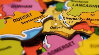 England Map Puzzle Blocks with English Cities London, Liverpool, Manchester, Bournemouth. Close-Up Video Background, Dolly Footage. Depth of Field.
