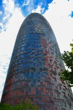 Barcelona 'daki Torre Glories' de renkli bir cepheli kurşun şekilli bir tasarım yer alıyor. Temel yeşillik modern mimariyle çelişiyor..