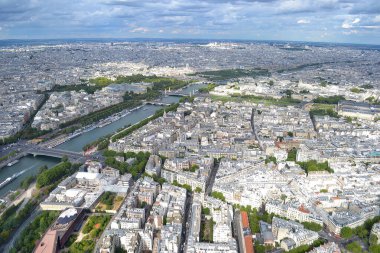 Paris, Fransa 'nın havadan bakış açısı, Seine Nehri, Louvre Müzesi, Tuileries Bahçesi ve parçalı bulutlu gökyüzü altında klasik Paris mimarisi..