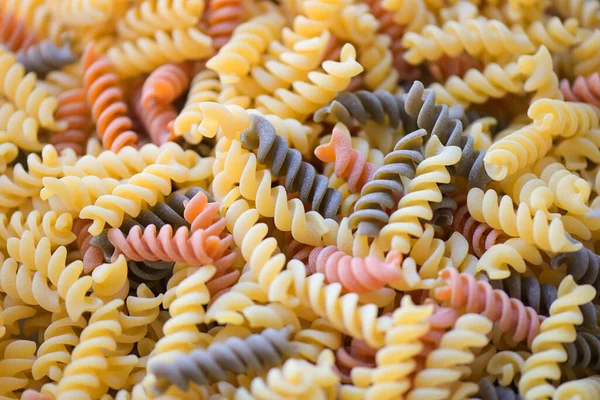 stock image Pasta raw macaroni background, close up raw macaroni spiral pasta uncooked delicious whole grain fusilli pasta for cooking food - top view 