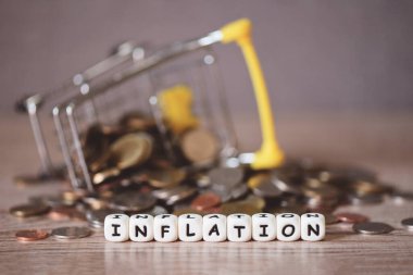 inflation with coin and shopping cart on wooden background, business economy inflation concept of money and finance - Rising grocery prices and surging cost more expensive things clipart