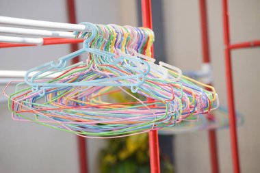 cloth hanger multi colored - colorful old plastic aluminum clothes hanger on the clothesline