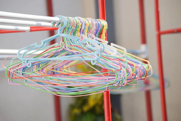 cloth hanger multi colored - colorful old plastic aluminum clothes hanger on the clothesline