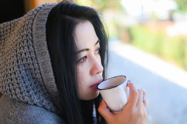 woman coffee with hand holding a cup in cafe, young woman drinking coffee relaxed woman smelling coffee at home in winter with cup coffee